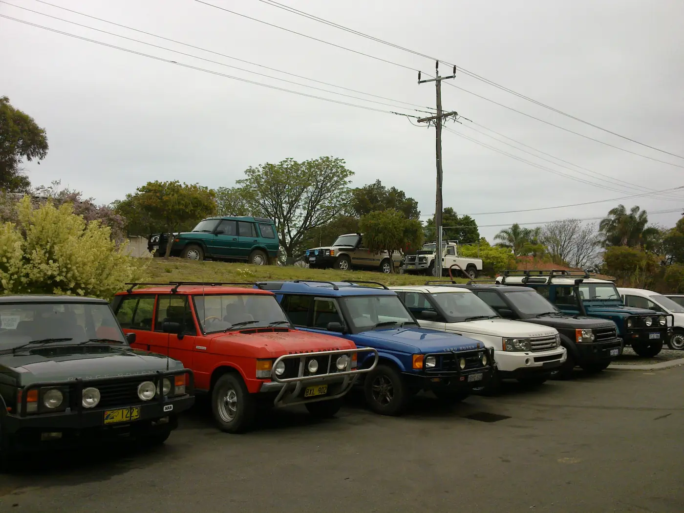 A line of Land Rovers and Range Rovers parked outside the Jordan Rover-Tech workshop