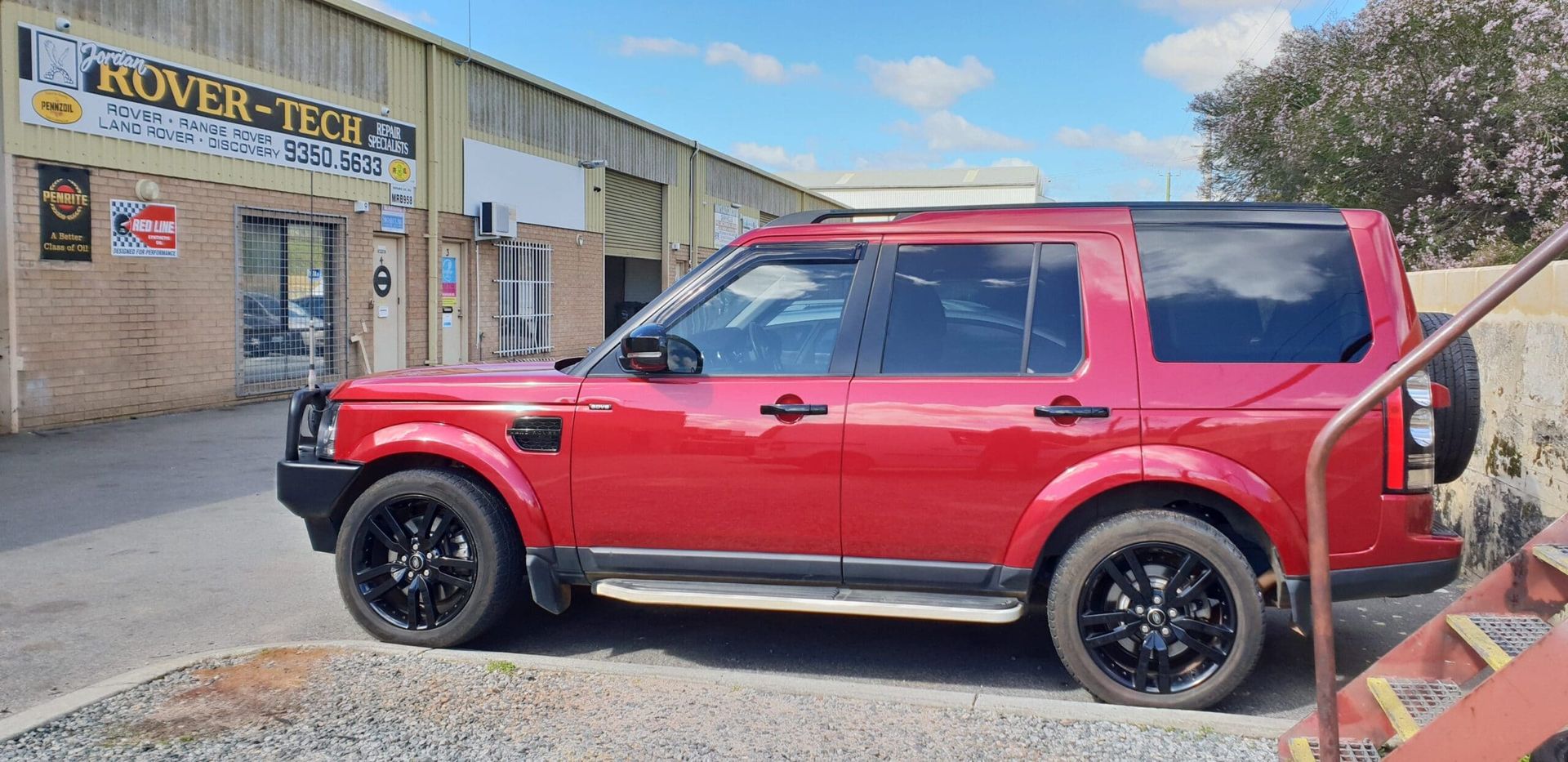 Red Land Rover Discovery outside the Jordan Rover-Tech workshop in Bentley