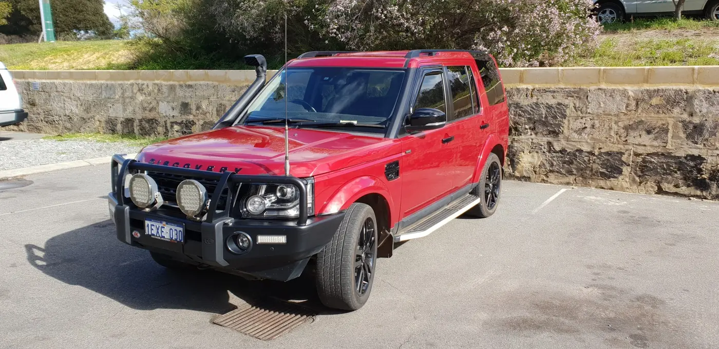 Red Discovery 4 fitted with bull bar and driving lights